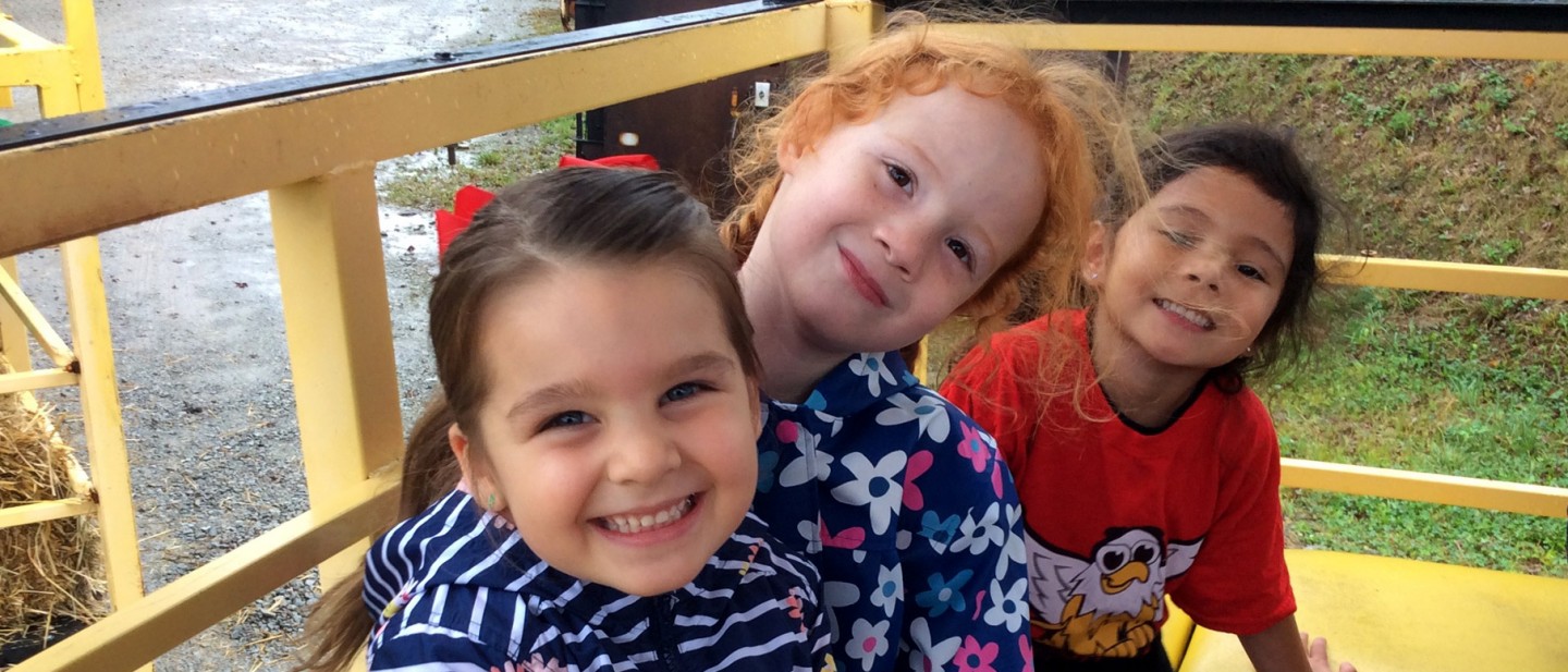 Photo of three little girls outside the Ƶ University Child Development Center